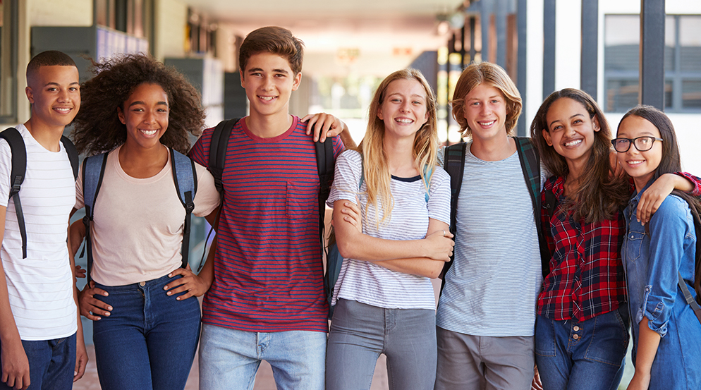 Happy Group Of Young Students In School